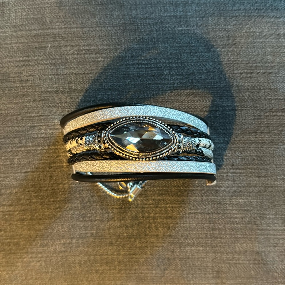 Multi-stranded leather bracelet with rhinestone embellishment.
